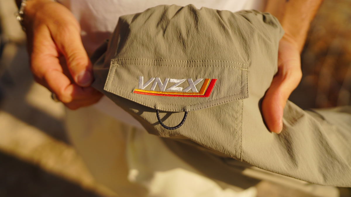 embroidered vnzx logo on the pocket of the olive shorts